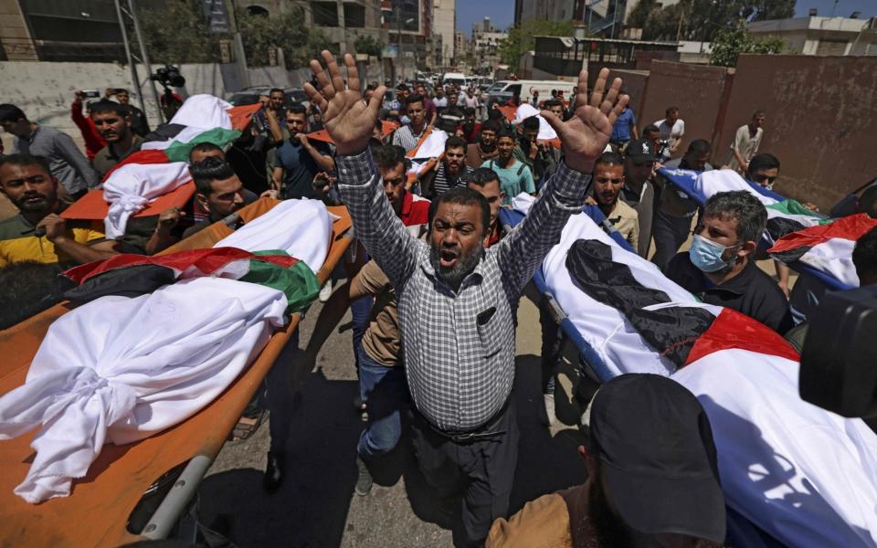 Palestinians in Gaza City take part in the funeral of the Abu Hatab family, which lost 10 members in an Israeli air strike. - AFP