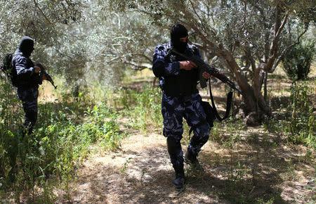 Palestinian security forces loyal to Hamas search for the main suspect in an assassination attempt against Palestinian Prime Minister Rami Hamdallah, in the central Gaza Strip March 22, 2018. REUTERS/Ibraheem Abu Mustafa