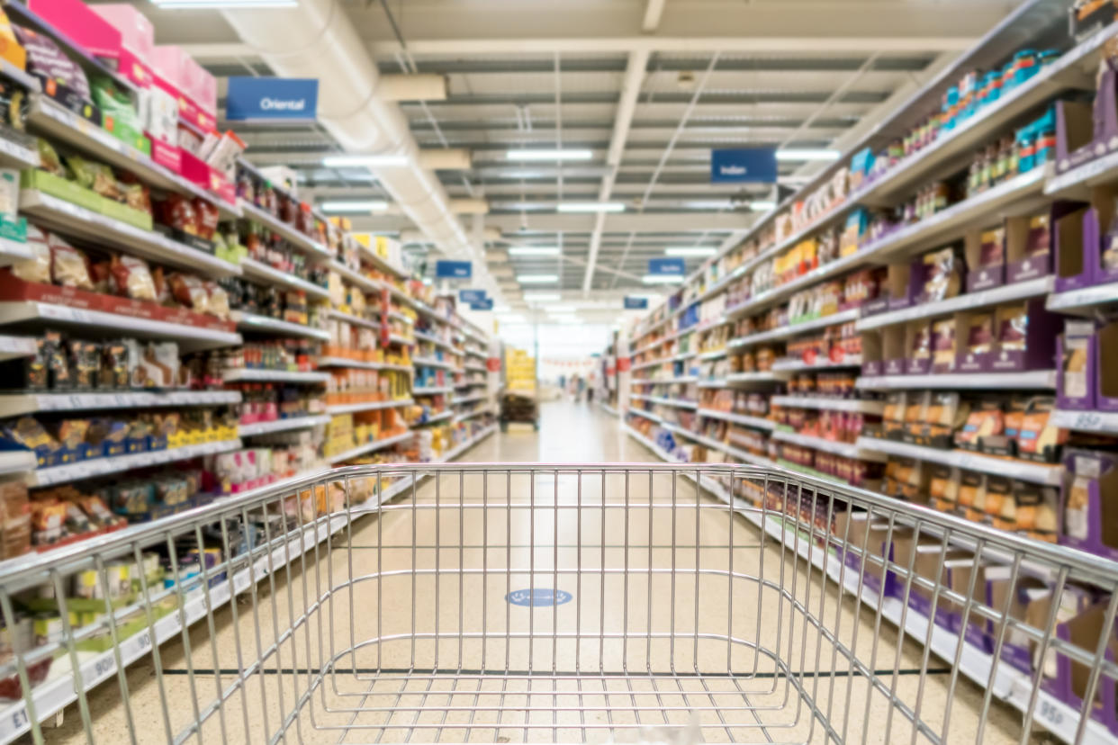 Unrecognizable supermarket aisle as background