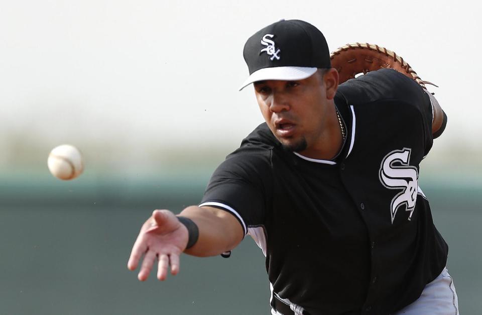 Chicago White Sox first baseman Jose Abreu tosses the ball during spring training baseball practice in Glendale, Ariz., Wednesday, Feb. 19, 2014. (AP Photo/Paul Sancya)