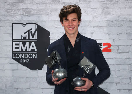 Canadian singer Shawn Mendes poses with his awards during the 2017 MTV Europe Music Awards at Wembley Arena in London, Britain November 12, 2017. REUTERS//Hannah McKay