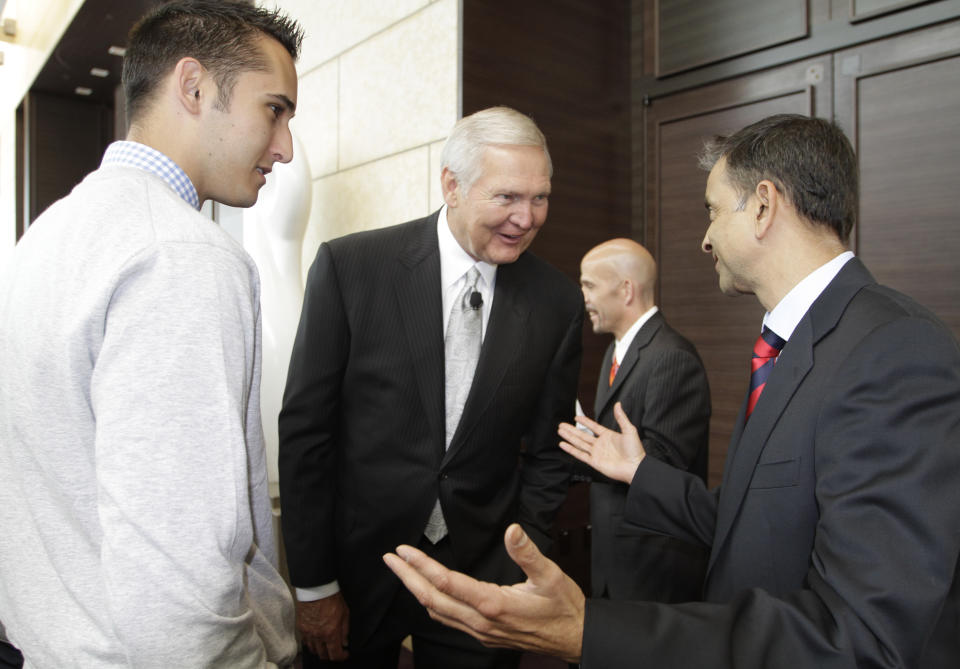 FILE - In this May 23, 2011, file photo, Jerry West, center, a member of the Golden State Warriors basketball club's Executive Board, visits with Warriors partial owner Vivek Rnadive, right, as West's son, Jonnie West, left, looks on before a news conference in San Francisco. Golfer Michele Wie revealed on Instagram earlier this week that she was engaged to Jonnie West, the Golden State Warriors' director of basketball operations and the son of NBA great Jerry West. (AP Photo/Eric Risberg, File)