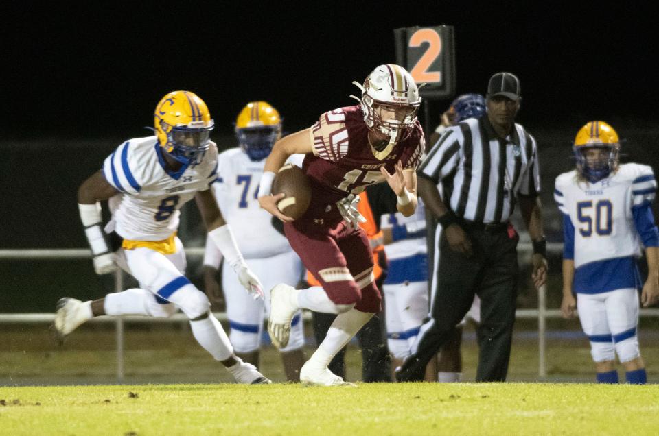 Northview High Schools' Wyatt Scruggs (No. 17) scrambles for extra yards as Chipley High School's Tyren Watford (No. 8) gives chase during Friday night's FSHAA Region 1-1R  Football Ball Championship game. Northview downed Chipley 42-6.  