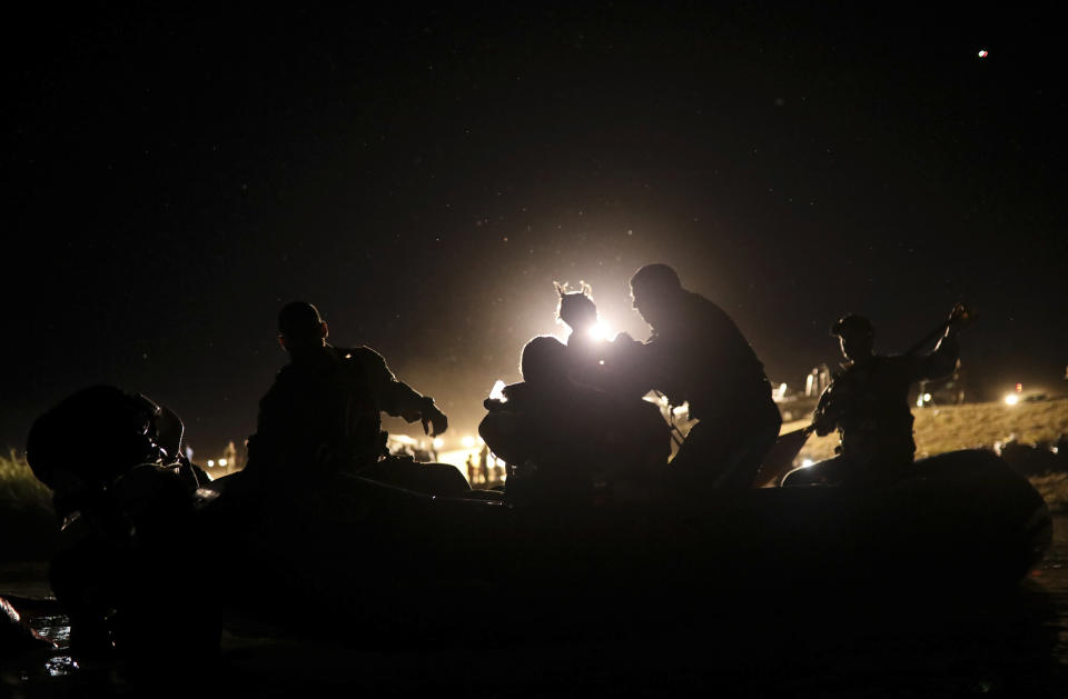 United States agents rescue a migrant child from the waters of the Rio Grande after her parents lost their footing and their children began to be swept away by the current on the American side of the border between Ciudad Acuna, Mexico, and Del Rio, Texas Thursday, Sept. 23, 2021. . (AP Photo/Felix Marquez)