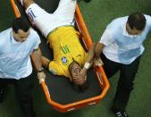 Brazil's Neymar grimaces as he is carried off the pitch after being injured during their 2014 World Cup quarter-finals against Colombia at the Castelao arena in Fortaleza July 4, 2014. REUTERS/Fabrizio Bensch