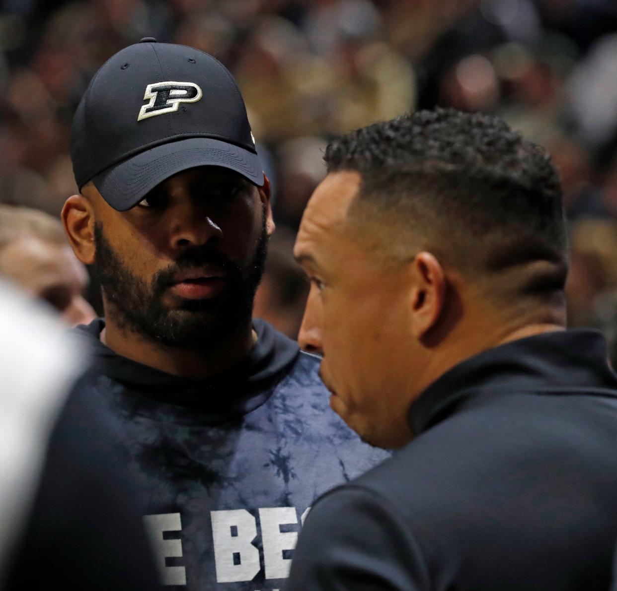 Purdue football cornerback coach Sam Carter talks to Purdue football head coach Ryan Walters during the NCAA men’s basketball game between the Purdue Boilermakers and the Illinois Fighting Illini, Sunday, March 5, 2023, at Mackey Arena in West Lafayette, Ind. 