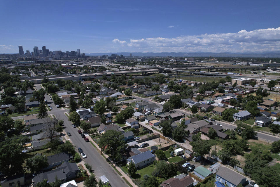 Trees dot the working class neighborhood of Globeville in Denver, July 24, 2023. Temperatures are hotter in America's low-income neighborhoods like the Denver suburb of Globeville, where many residents are low-income and people of color living in stretches of concrete that hold heat like a cast-iron skillet. Comparatively, in wealthy neighborhoods such as Country Club, mansions pocket a sea of vegetation which cools the area. (AP Photo/Brittany Peterson)