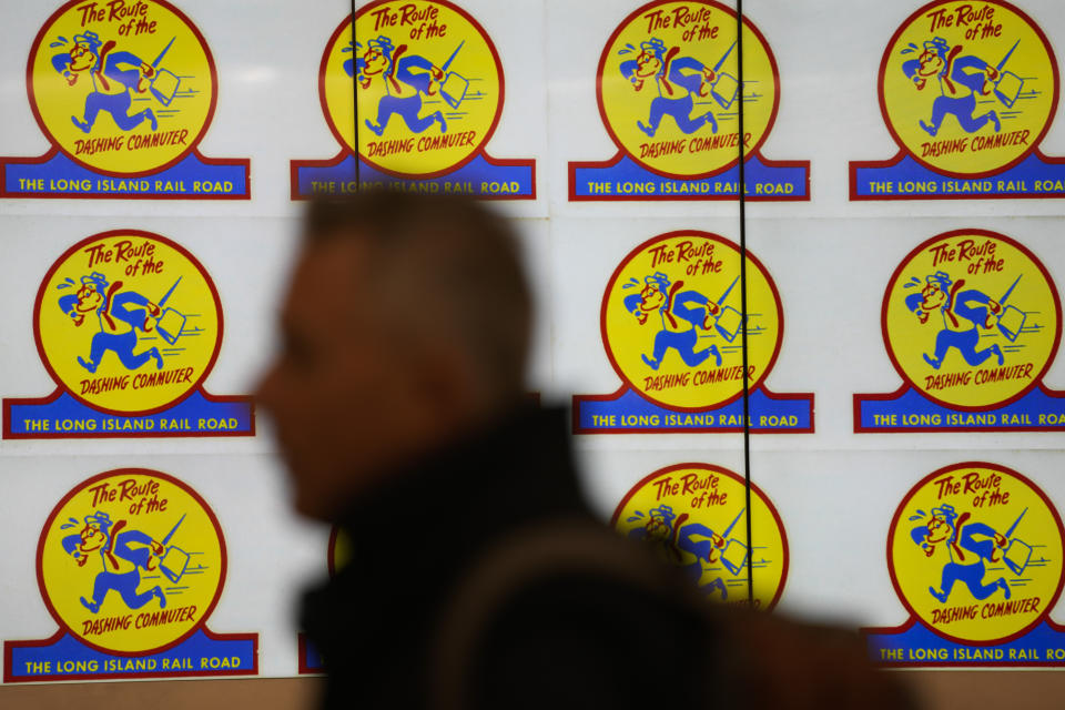 A man walks past a screen displaying Long Island Railroad logos in the new annex of Grand Central Station in New York, Wednesday, Jan. 25, 2023. After years of delays and massive cost overruns, one of the world's most expensive railway projects on Wednesday began shuttling its first passengers between Long Island to a new annex to New York City's iconic Grand Central Terminal (AP Photo/Seth Wenig)