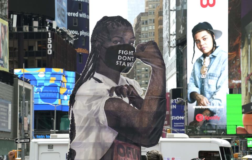 A statue of "Elena the Essential Worker" in Times Square on Aug. 31, 2020, in New York City.