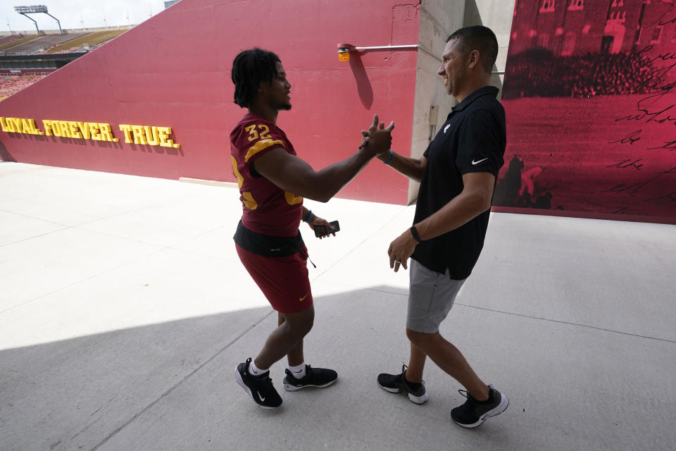 Iowa State head coach Matt Campbell greets linebacker Gerry Vaughn (32) during an NCAA college football media day, Friday, Aug. 4, 2023, in Ames, Iowa. (AP Photo/Charlie Neibergall)