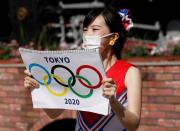 Cheerleaders perform at Shimbashi Station one day before Tokyo 2020 Olympics