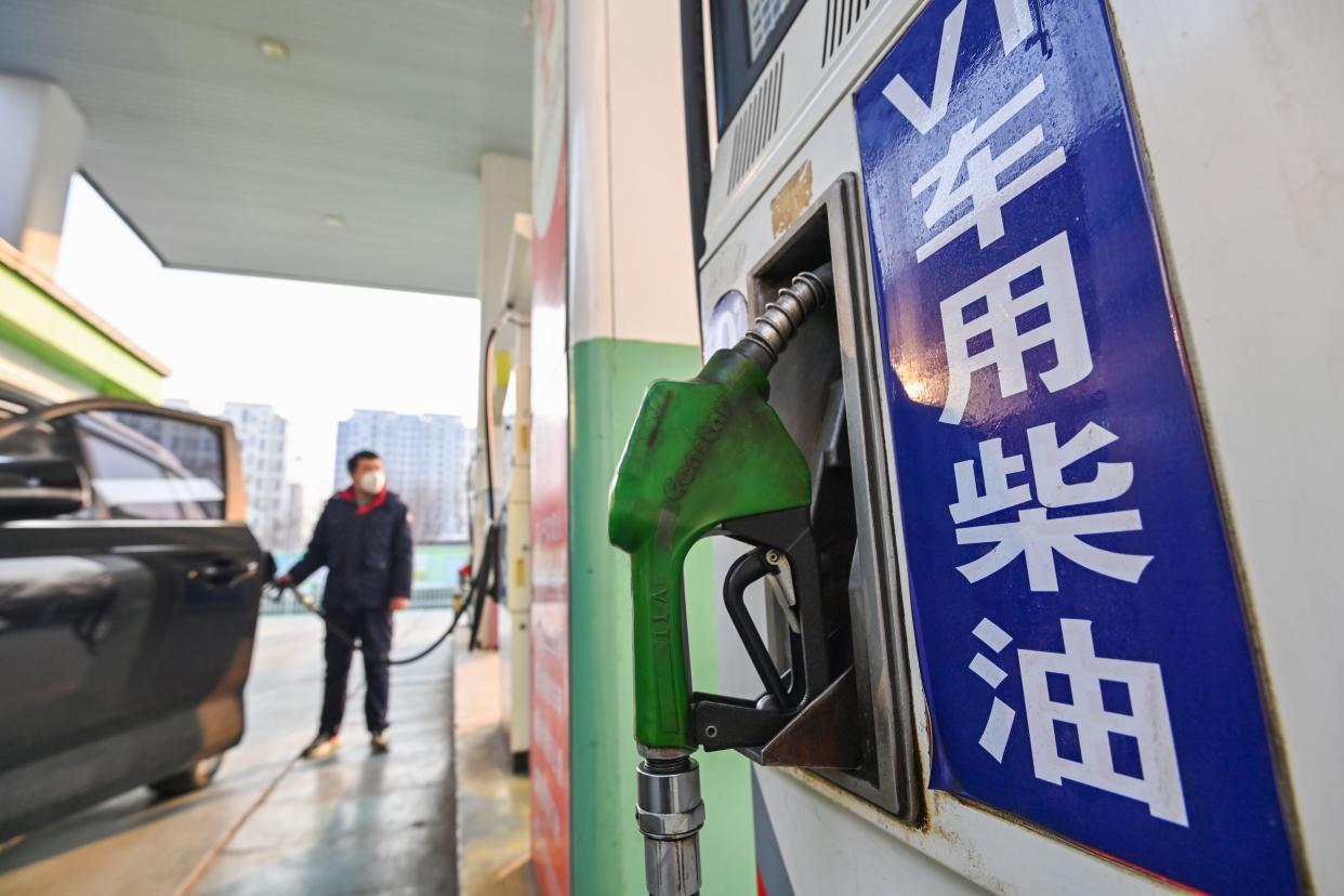 A staff member refuels a vehicle at a gas station in Qingzhou, east China's Shandong Province, Jan. 3, 2023.  China will raise the retail prices of gasoline and diesel from Wednesday, based on the recent rise in international oil prices.   Gasoline and diesel prices will be up by 250 yuan about 36 U.S. dollars per tonne and 240 yuan per tonne, respectively, the National Development and Reform Commission said in a Tuesday statement. (Photo by Wang Jilin/Xinhua via Getty Images)
