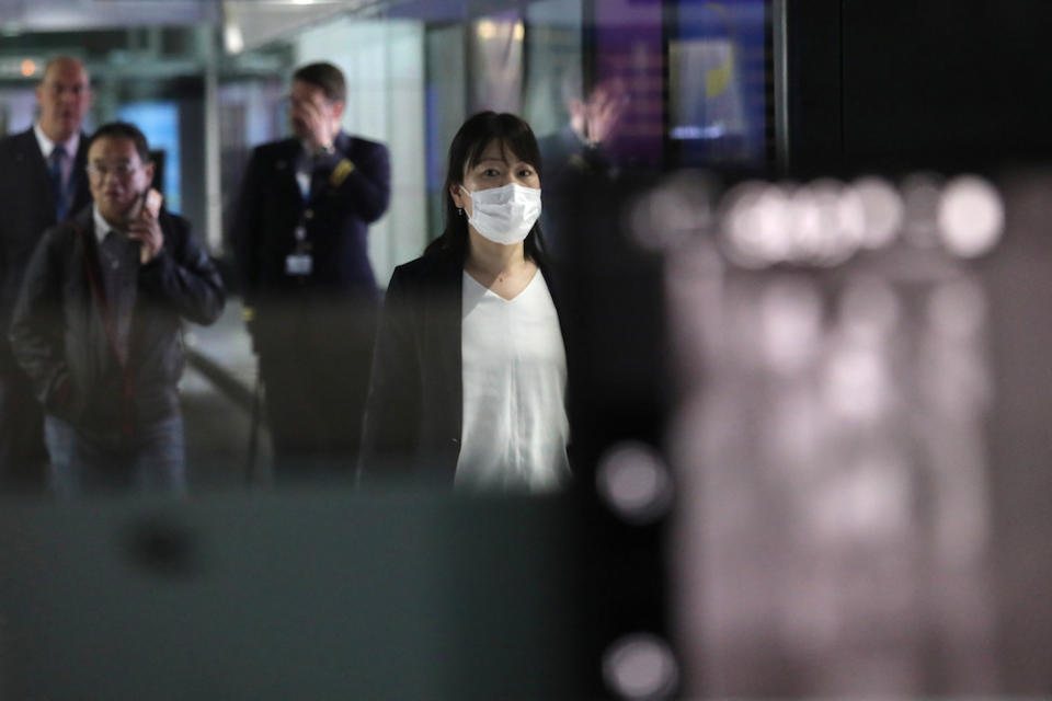 A woman with a mask passes by a thermal screening point at the international arrival terminal of Kuala Lumpur International Airport in Sepang January 21, 2020. — Reuters pic