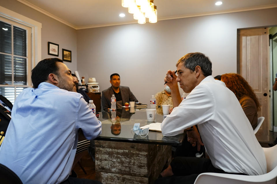 Mayor Trey Mendez, left, and Democratic candidate for Texas governor Beto O'Rourke, right, discuss areas of concern and progress within the city of Brownsville, Texas, Friday, Feb. 11, 2022, during a meeting for his "Keeping The Lights On" campaign ahead of the primary election. (Denise Cathey/The Brownsville Herald via AP)