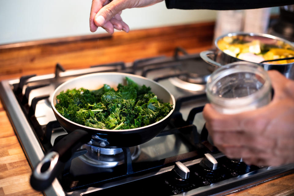 Seasoning kale while cooking