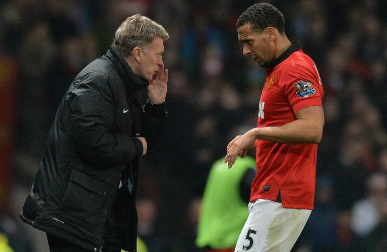 Manchester United's manager David Moyes (L) talks to Rio Ferdinand during their English Premier League match against Manchester City, at Old Trafford, on March 25, 2014