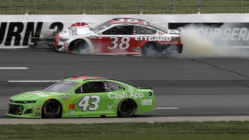 Driver John Hunter Nemechek (38) bangs into the wall after losing a tire as Bubba Wallace (43) passes safely below during a NASCAR Cup Series auto race, Sunday, Aug. 2, 2020, at the New Hampshire Motor Speedway in Loudon, N.H. (AP Photo/Charles Krupa)