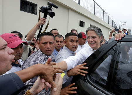 Ecuadorean presidential candidate Guillermo Lasso is greeted by supporters after casting his vote during the presidential election in Guayaquil, Ecuador April 2, 2017. REUTERS/Henry Romero