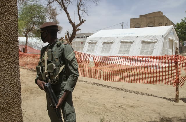 A Malian soldier stands near the isolation tent for patients with coronavirus in Timbuktu (Baba Ahmed/AP)