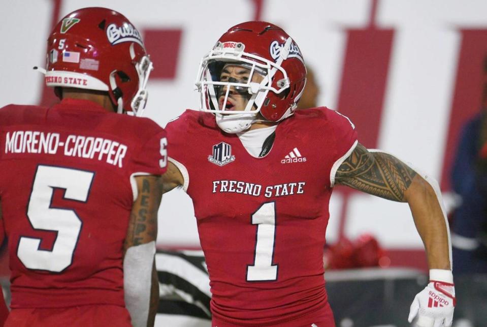 Fresno State wideout Nikko Remigio, right, celebrates his touchdown against Wyoming with Jalen Moreno-Cropper, on Friday, Nov. 25, 2022 in Fresno. The Bulldogs won 30-0.