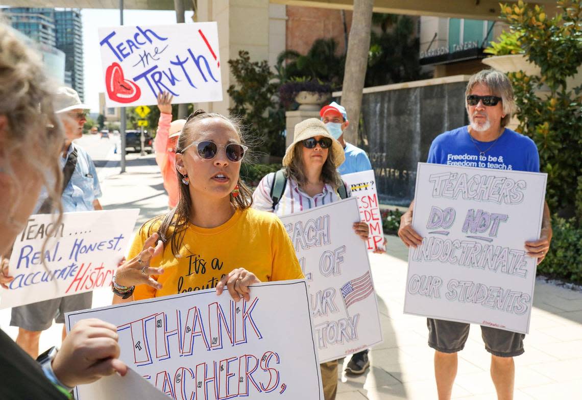 Alyssa Knight, left, 31, Dunedin Highland Middle School’s teacher of the year, protests outside the Moms for Liberty National Summit Friday, July 15, 2022, in Tampa. Gov. Ron DeSantis spoke inside.