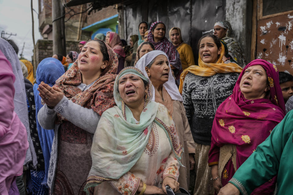 Family members and relatives cry after a boat carrying people including children capsized in Jhelum river on the outskirts of Srinagar, Indian controlled Kashmir, Tuesday, April. 16, 2024. Rescue operation is continuing for the several missing people. (AP Photo/Mukhtar Khan)