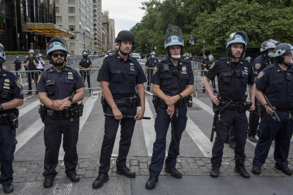 Police officers guard the Trump International Hotel in Manhattan's Columbus Circle as a large demonstration approaches on June 3. (Photo: Andrew Lichtenstein via Getty Images)