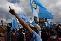 Protesters gather outside Congress in Guatemala City, Saturday, Nov. 21, 2020. Hundreds of protesters were protesting in various parts of the country Saturday against Guatemalan President Alejandro Giammattei and members of Congress for the approval of the 2021 budget that reduced funds for education, health and the fight for human rights. (AP Photo/Moises Castillo)