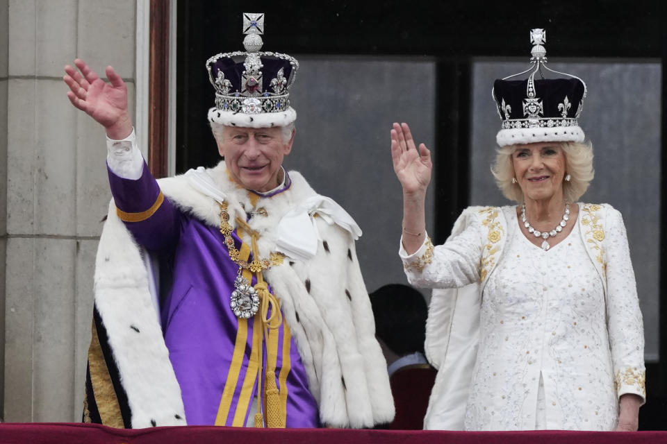 FILE - Britain's King Charles III and Queen Camilla wave to the crowds from the balcony of Buckingham Palace after the coronation ceremony in London, Saturday, May 6, 2023. At an age when many of his contemporaries have long since retired, King Charles III is not one to put his feet up. The king will mark his 75th birthday on Tuesday, Nov. 14, 2023, by highlighting causes close to his heart. With Queen Camilla at his side, Charles will visit a project that helps feed those in need by redistributing food that might otherwise go to landfills. (AP Photo/Frank Augstein, File)