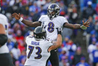 Baltimore Ravens quarterback Lamar Jackson (8) celebrates a 61-yard touchdown play with Marshal Yanda during the second half of an NFL football game against the Buffalo Bills in Orchard Park, N.Y., Sunday, Dec. 8, 2019. (AP Photo/John Munson)