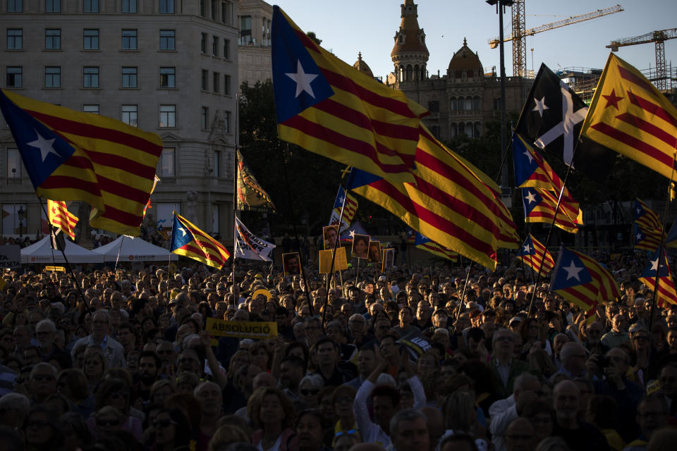 Demonstrators hold independence flags during a protest in downtown Barcelona, Spain, Wednesday, June 12, 2019. Catalan separatist leaders and activists told their Supreme Court trial on Wednesday they were exercising their democratic rights when they held a banned referendum on breaking away from Spain, denying charges of rebellion and sedition. (AP Photo/Emilio Morenatti)