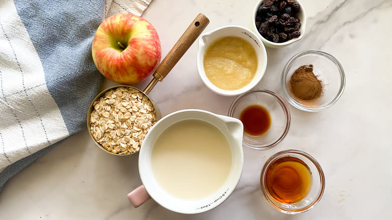 recipe ingredients in jars and measuring cups on marble countertop