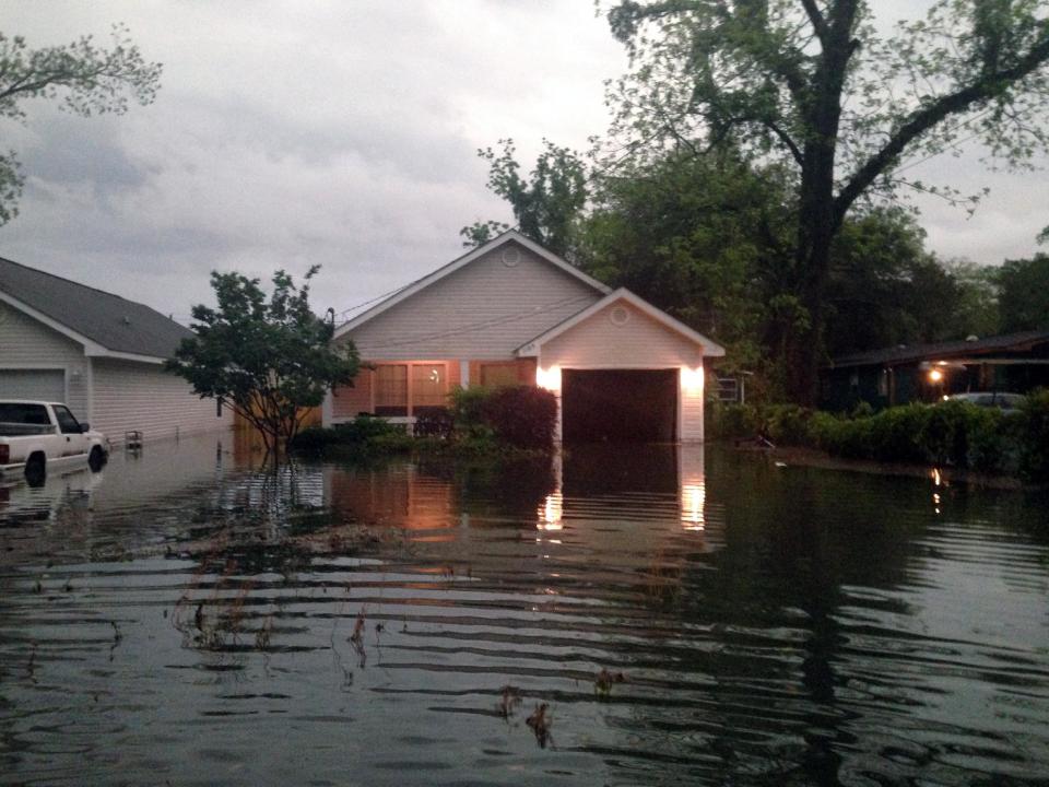 In this photo provided by Kyle Smith, floodwaters surround Smith's home in Pensacola, Fla. on Wednesday, April 30, 2014. Smith had to evacuate his home with his 18-month-old son Tuesday night after severe weather hit the Florida Panhandle, causing widespread flooding. (AP Photo/Kyle Smith)