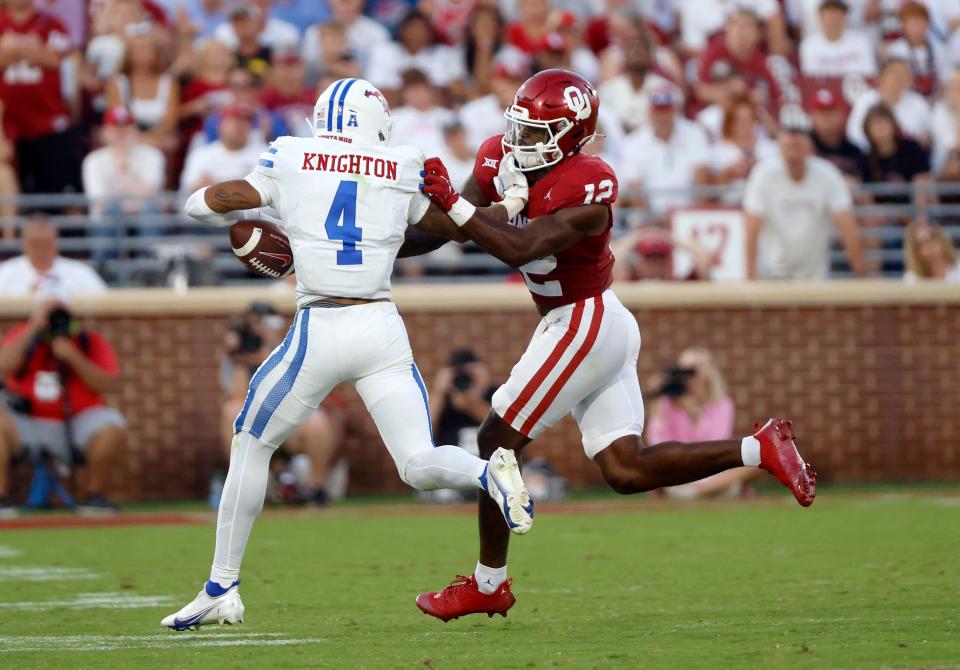 OU's Key Lawrence (12) forces a fumble from SMU's Jaylan Knighton (4) in the second half of the Sooners' 28-11 win Saturday in Norman.