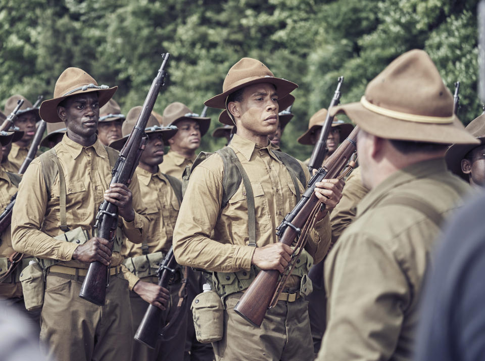 This image released by Vertical Entertainment shows Trai Byers, center, in a scene from "The 24th." The film, available for digital rental Friday, dramatizes the 1917 Houston riot in which soldiers of the all-black Twenty-fourth United States Infantry Regiment, stationed in segregated Texas, mutinied after harassment by the Houston Police Department. (Vertical Entertainment via AP)