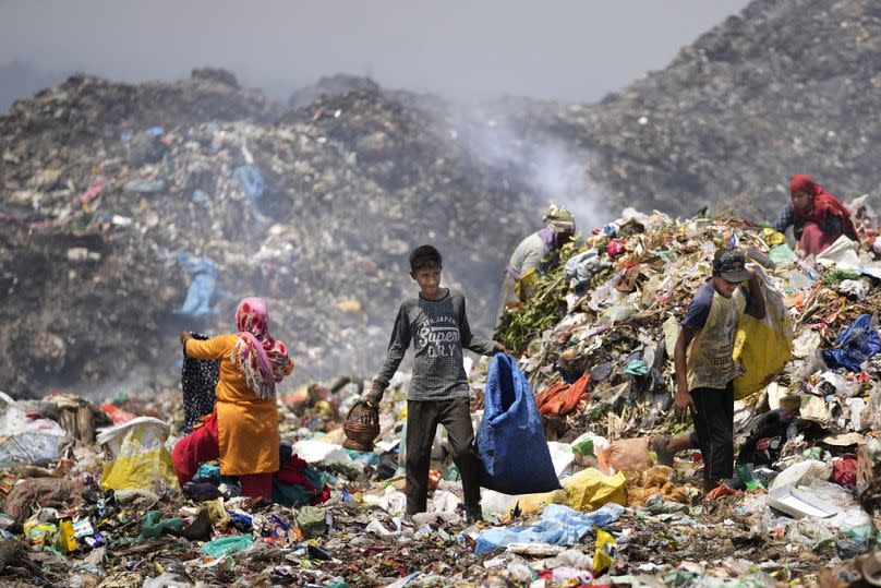 Waste picker Rajdin, 17, looks for recyclable material in the punishing heat of Jammu