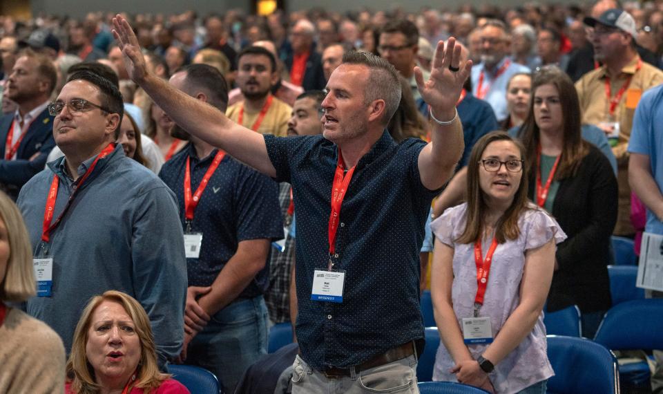 Matt Hunter, center, and others sing during the Southern Baptist Convention, Tuesday, June 11, 2024 at the Indiana Convention Center.