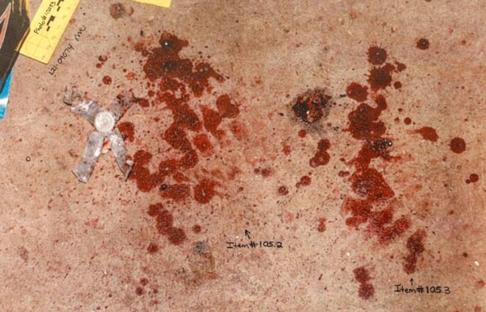 Crime scene photos show blood on the floor of the dog feed house (Law & Crime)