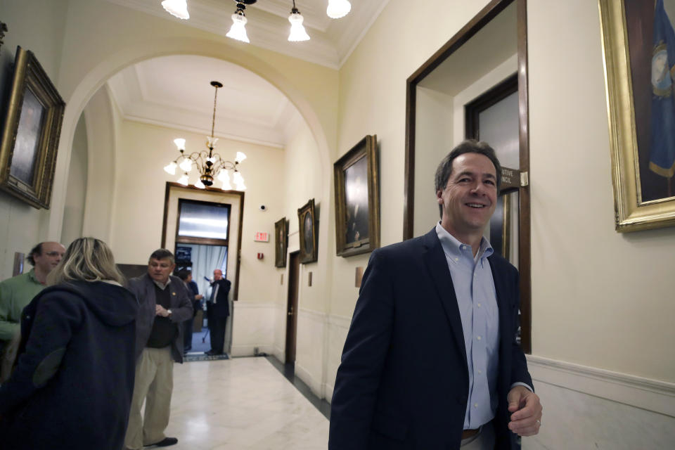 FILE - In this Tuesday, Nov. 12, 2019, file photo, Democratic presidential candidate Montana Gov. Steve Bullock walks through a hallway at the State House, in Concord, N.H. after filing to be placed on the New Hampshire primary ballot. The quadrennial chaos has quieted down over at the New Hampshire secretary of state’s office with the closing of the filing period for the first-in-the-nation presidential primary. (AP Photo/Elise Amendola, File)