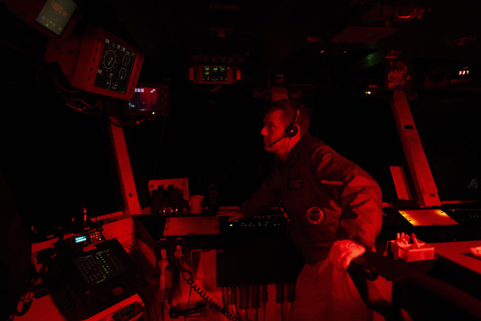 The Air Boss of the USS Dwight D. Eisenhower oversees flight deck control operations from the bridge of the aircraft carrier in the Red Sea on Tuesday, June 11, 2024. (AP Photo/Bernat Armangue)