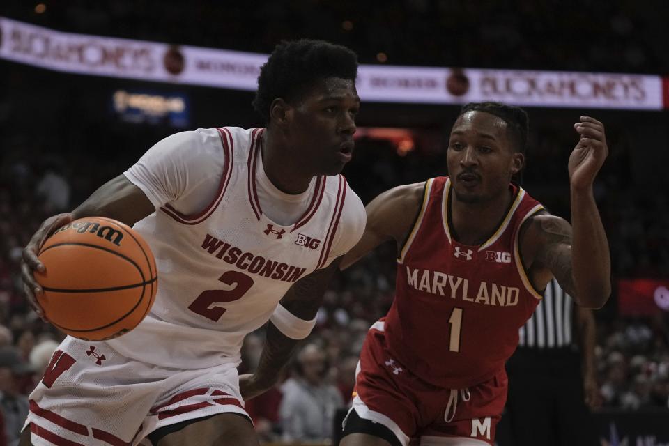 Wisconsin's AJ Storr drives past Maryland's Jahmir Young during the second half of an NCAA college basketball game Tuesday, Feb. 20, 2024, in Madison, Wis. (AP Photo/Morry Gash)