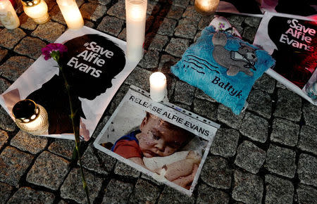 Candles and placards are pictured during a protest in support of Alfie Evans, in front of the British Embassy building in Warsaw, Poland April 26, 2018. REUTERS/Kacper Pempel