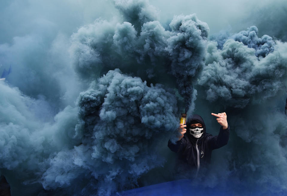 Fans gesture in the smoke in Sweden