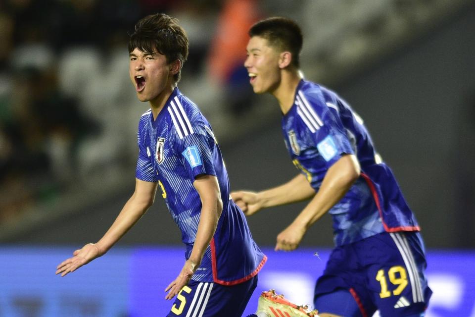 Japan's Riku Yamane, left, celebrates scoring his side's first goal against Colombia during a FIFA U-20 World Cup Group C soccer match at Diego Maradona stadium in La Plata, Argentina, Wednesday, May 24, 2023. (AP Photo/Gustavo Garello)