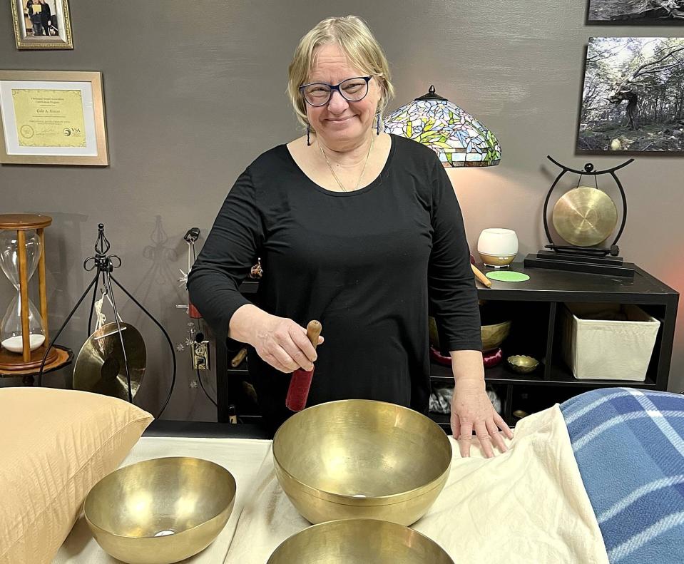 Gale Simon, owner of Acoustic Therapy Partners, with a few of her therapeutic singing bowls in her studio at 2775 W. 17th St. in Erie on Jan. 4, 2023.