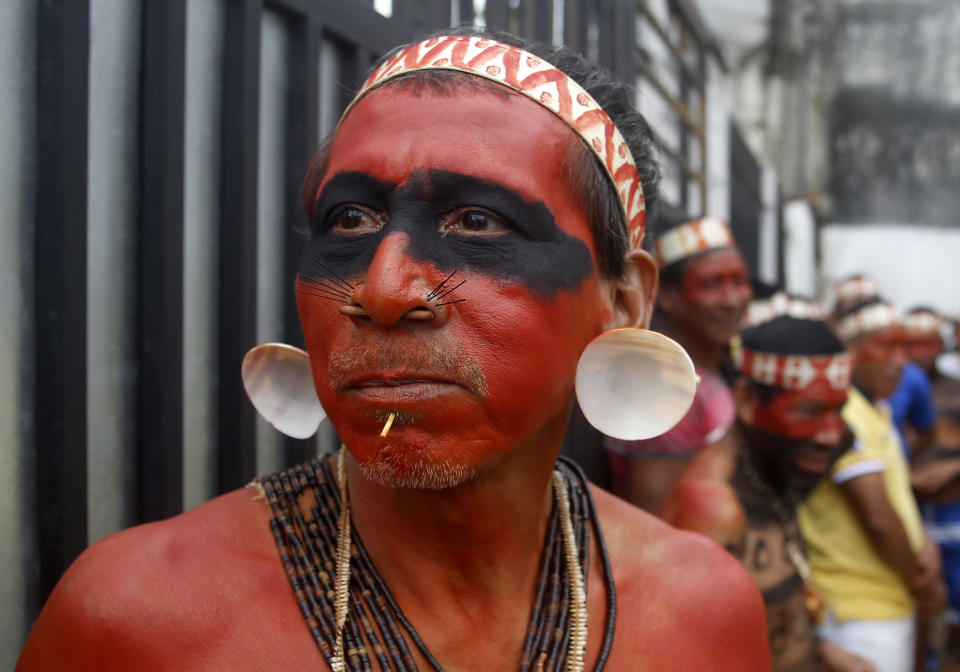 A Matis Indigenous man takes part in a protest against the disappearance of Indigenous expert Bruno Pereira and freelance British journalist Dom Phillips, in Atalaia do Norte, Vale do Javari, Amazonas state, Brazil, Monday, June 13, 2022. Brazilian police are still searching for Pereira and Phillips, who went missing in a remote area of Brazil's Amazon a week ago. (AP Photo/Edmar Barros)