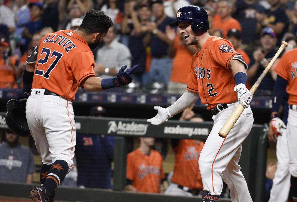 Houston Astros' Jose Altuve, left, celebrates his solo home run off Los Angeles Angels starting pitcher Jaime Barria with Alex Bregman during the first inning of a baseball game Friday, Sept. 20, 2019, in Houston. (AP Photo/Eric Christian Smith)