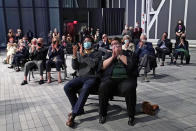 Members of an audience of 150 people applaud at the conclusion of a concert by the New York Philharmonic, which performed together for the first time since March 10, 2020, at The Shed in Hudson Yards, Wednesday, April 14, 2021, in New York. (AP Photo/Kathy Willens)