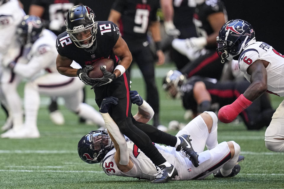 Atlanta Falcons wide receiver KhaDarel Hodge (12) runs the ball after making a catch against Houston Texans linebacker Jake Hansen (35) in the first half of an NFL football game in Atlanta, Sunday, Oct. 8, 2023. (AP Photo/Mike Stewart)