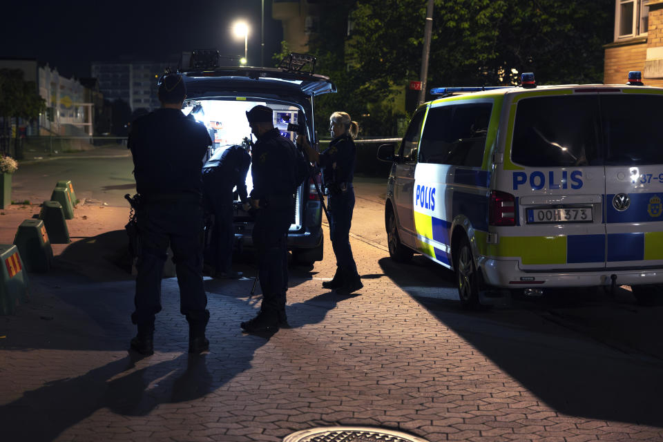 Police stand on the scene after a man was shot dead and another person was injured in Jordbro, south of Stockholm, in the early hours of Thursday, Sept. 28, 2023. Three people were killed overnight in separate incidents in Sweden as deadly violence linked to a feud between criminal gangs escalated. Late Wednesday, an 18-year-old man was shot dead in a Stockholm suburb. Hours later, a man was killed and another was wounded in a shooting in Jordbro, south of the Swedish capital. (Nils Petter Nilsson/TT News Agency via AP)